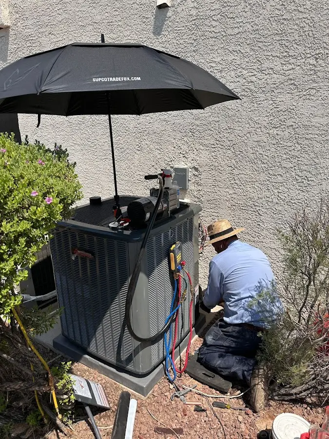 HVAC technician performing outdoor AC maintenance in Greencastle